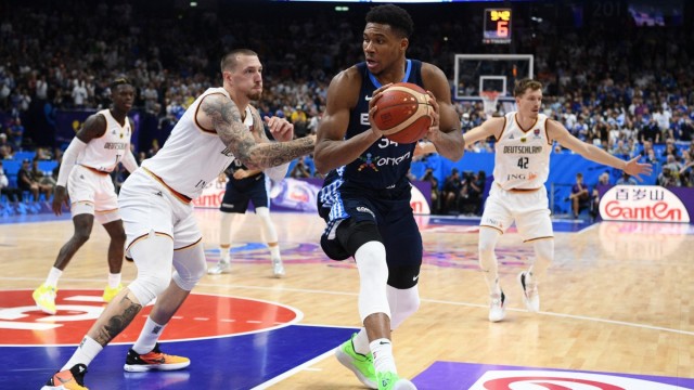 European Basketball Championship: Giannis Antetokounmpo (center), arguably the most accomplished basketball player in the world, is stopped by Daniel Theis (left) in this fight.